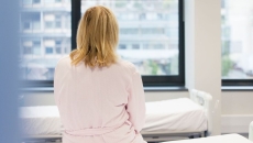 Person sitting on hospital bed