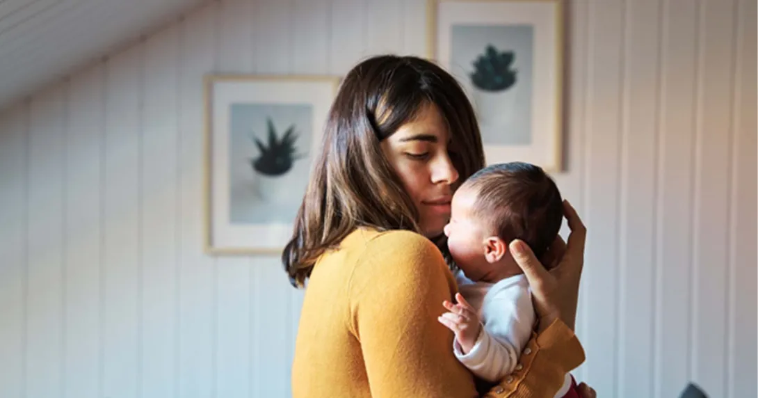 new mother in yellow holding infant new mother in yellow holding infant