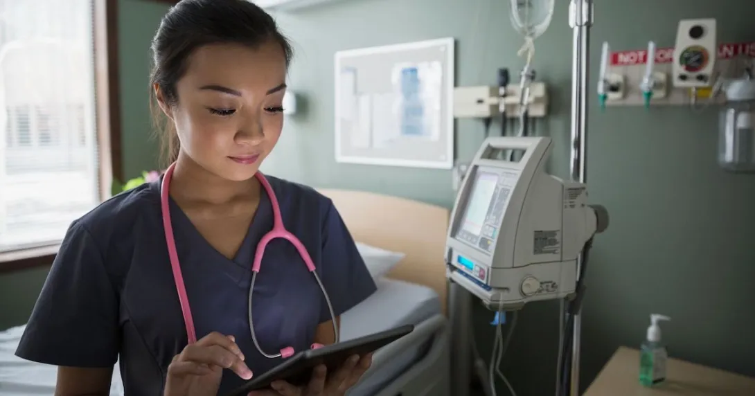 A doctor reviewing a patient's file on a digital tablet A doctor reviewing a patient's file on a digital tablet