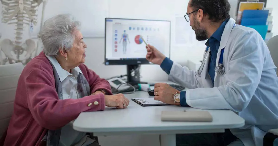 Doctor showing medical data on a screen to a patient Doctor showing medical data on a screen to a patient