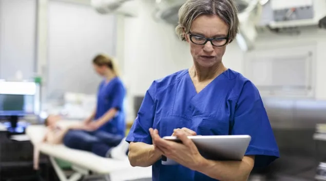 medical professional using a tablet