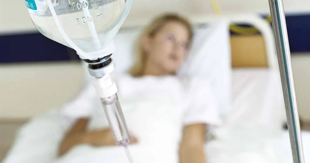 Patient lying in hospital bed with IV drip Patient lying in hospital bed with IV drip