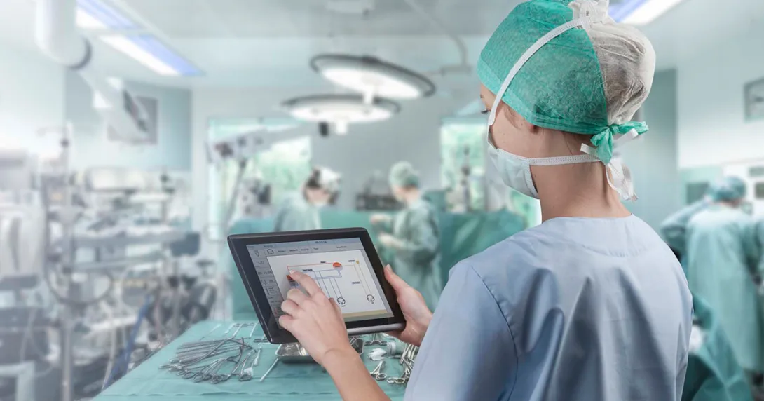 Healthcare worker in surgery room with tablet Healthcare worker in surgery room with tablet