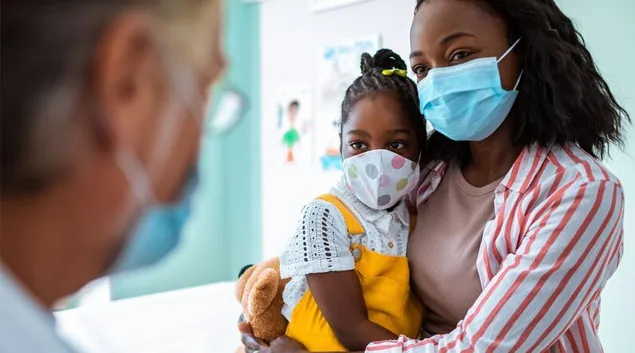 Patient and child in mask visiting doctor