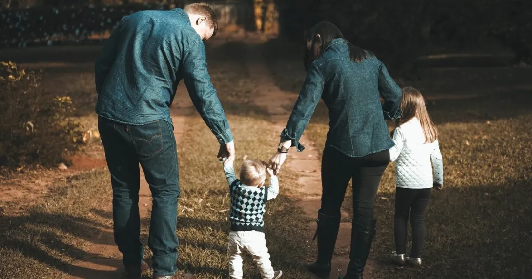 A family of four walking side by side